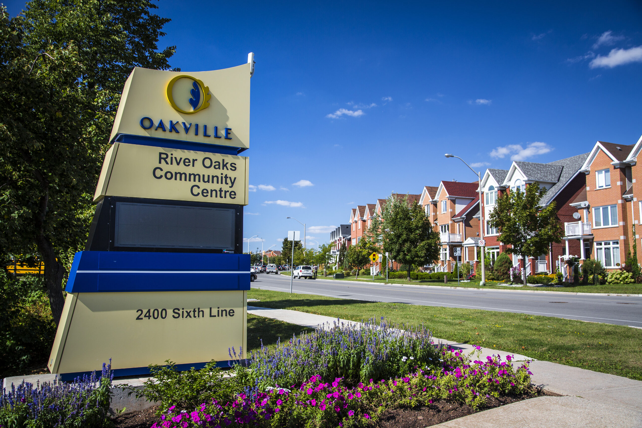 Uptown Core Oakville signage with landscaped flower beds