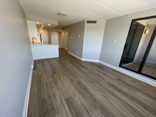 Living room with view to kitchen and entryway at 100 Bronte Street Unit 314 Oakville