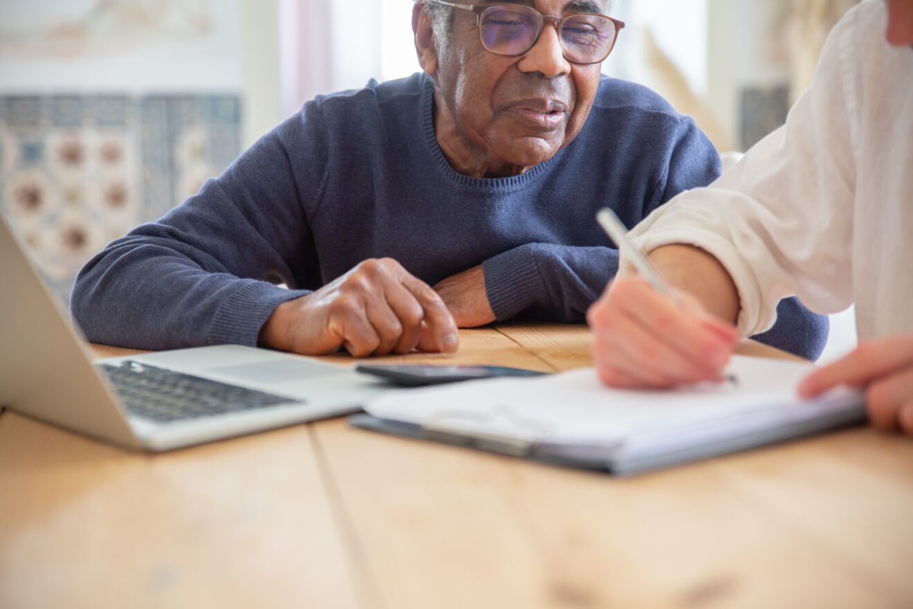 Selling a home through probate in Ontario: a senior receiving help with paperwork at home