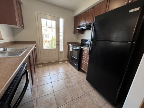 Kitchen with appliances and a walkout to the yard, 829 Fowles Court, Hawthorne Village, Milton