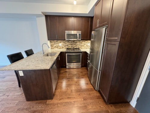Kitchen breakfast bar by the suite entry, Suite 319, Windows on the Green, Erin Mills, Mississauga