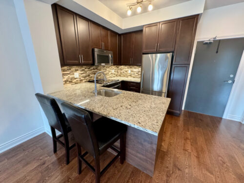 Kitchen with granite island and stainless steel appliances, Suite 319, Windows on the Green, Erin Mills, Mississauga