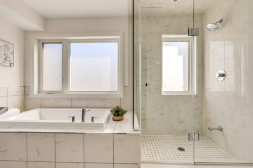 primary ensuite with soaker tub and glass shower william duncan road downsview park toronto